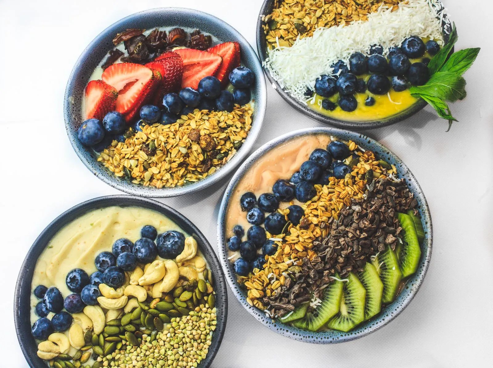 Colorful smoothie bowls topped with fruits and seeds, perfect for a healthy breakfast.